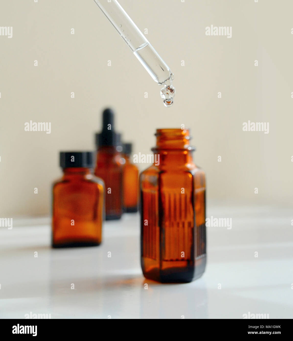 Various sizes of brown / amber medicinal bottles, including some with pipettes. Stock Photo