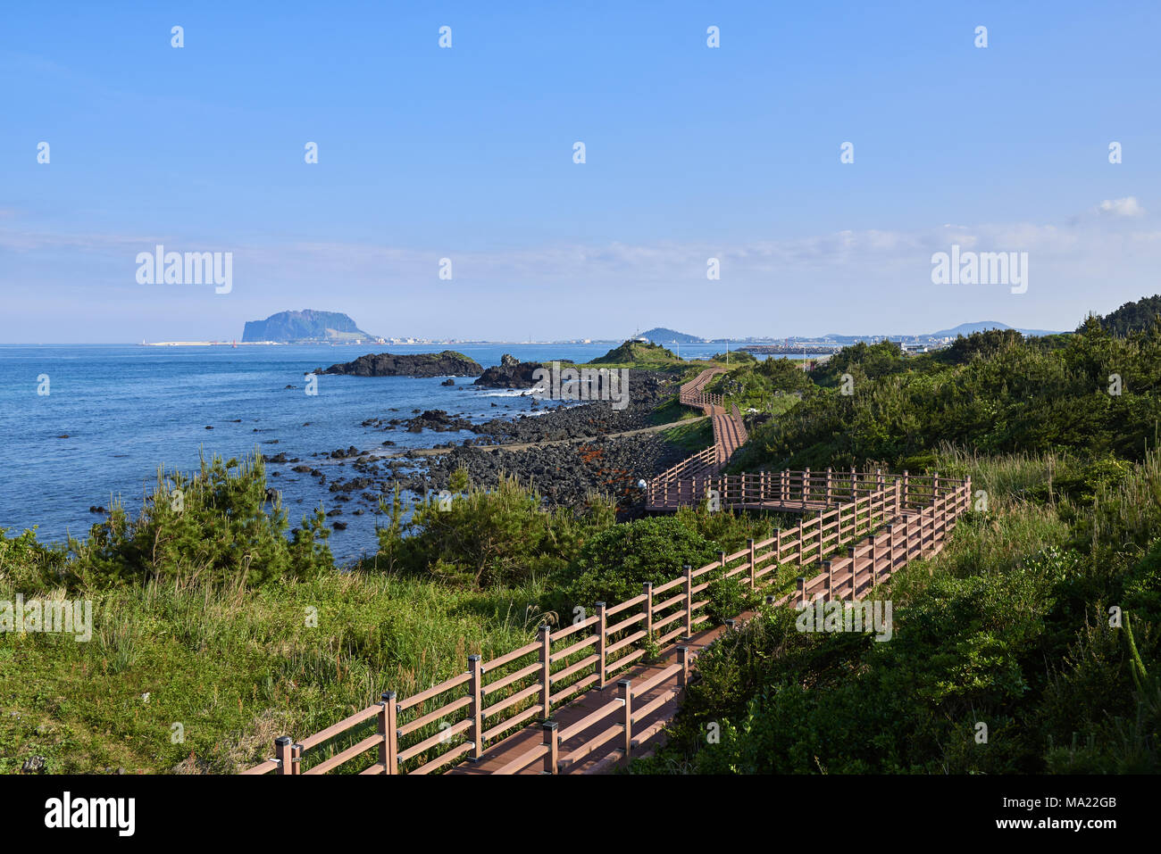 Jongdalri coast trail in Jeju island, Korea. The trail is famous for beautiful scenery. In the walkway there is an observation platform. Stock Photo