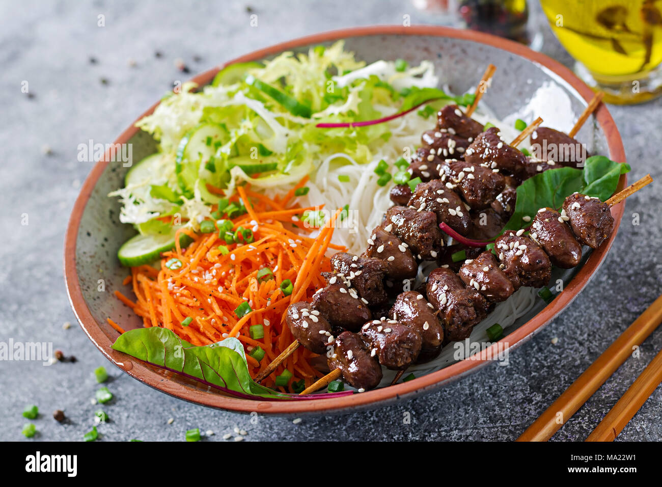 Chicken hearts in spicy sauce, noodles and vegetable salad. Healthy food. Stock Photo