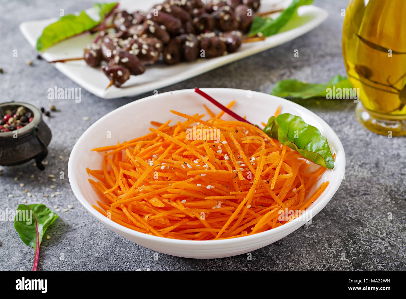 Carrot salad and chicken hearts in spicy sauce . Healthy food. Top view Stock Photo
