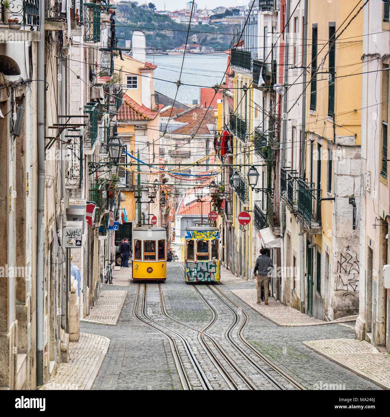 7 March 2018: Lisbon Portugal - The Bica Lift, or Elevador da Bica, in the Misericordia district, a funicular railway line. Here the two trams pass ea Stock Photo