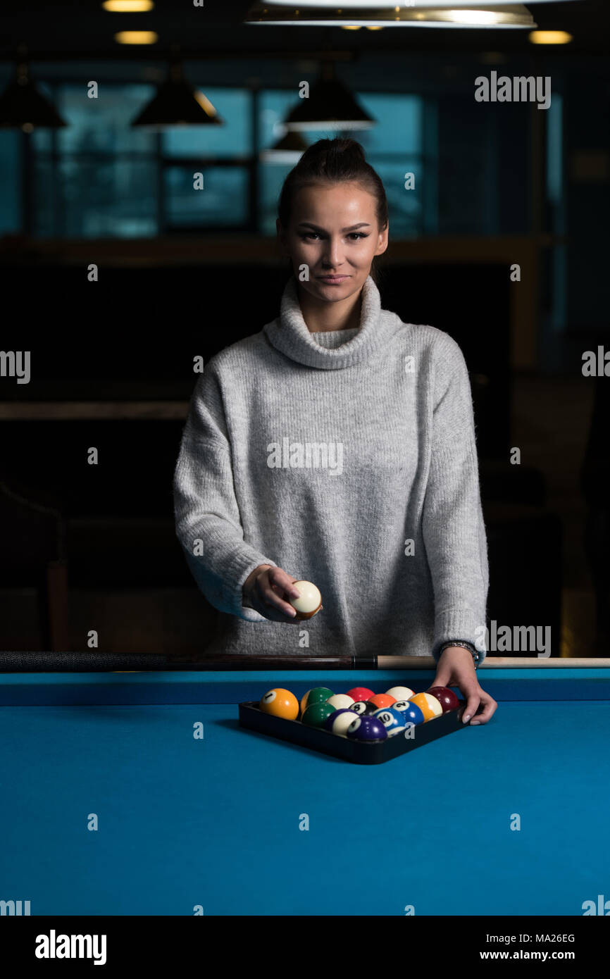 Premium Photo  Beautiful young girl came on a weekend to play billiards  for curiosity concept of a girl playing billiards