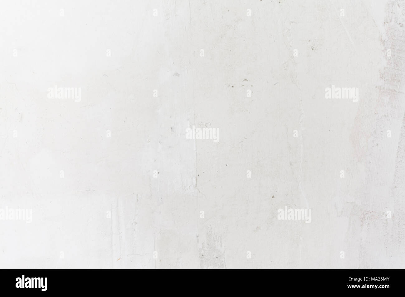 White concrete wall. Small cracks on the surface Stock Photo