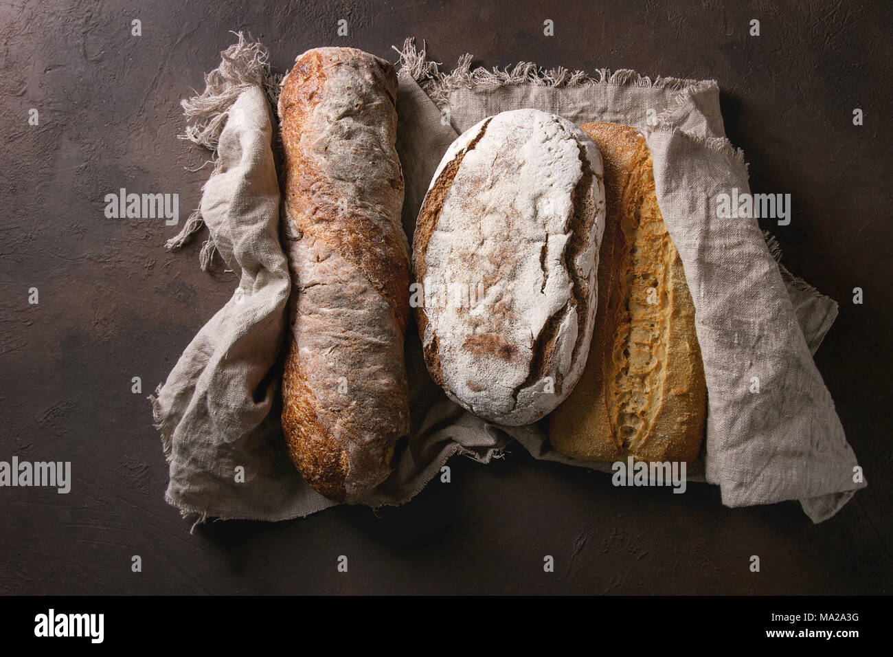 Variety of loafs fresh baked artisan rye, white and whole grain bread ...