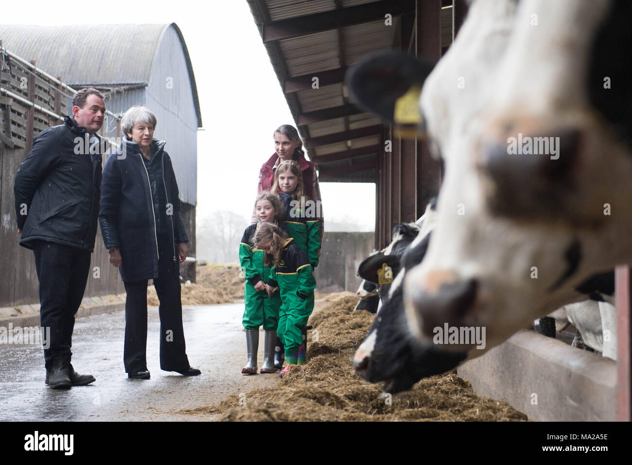 Prime Minister Theresa May is shown around Fairview Farm by owners Stephen and Susanne Jackson and their three daughters Hannah, Abbie and Emily (left to right not given) in Bangor, Northern Ireland during a tour of the four nations of the UK, with a promise to keep the country united one year before Brexit. Stock Photo