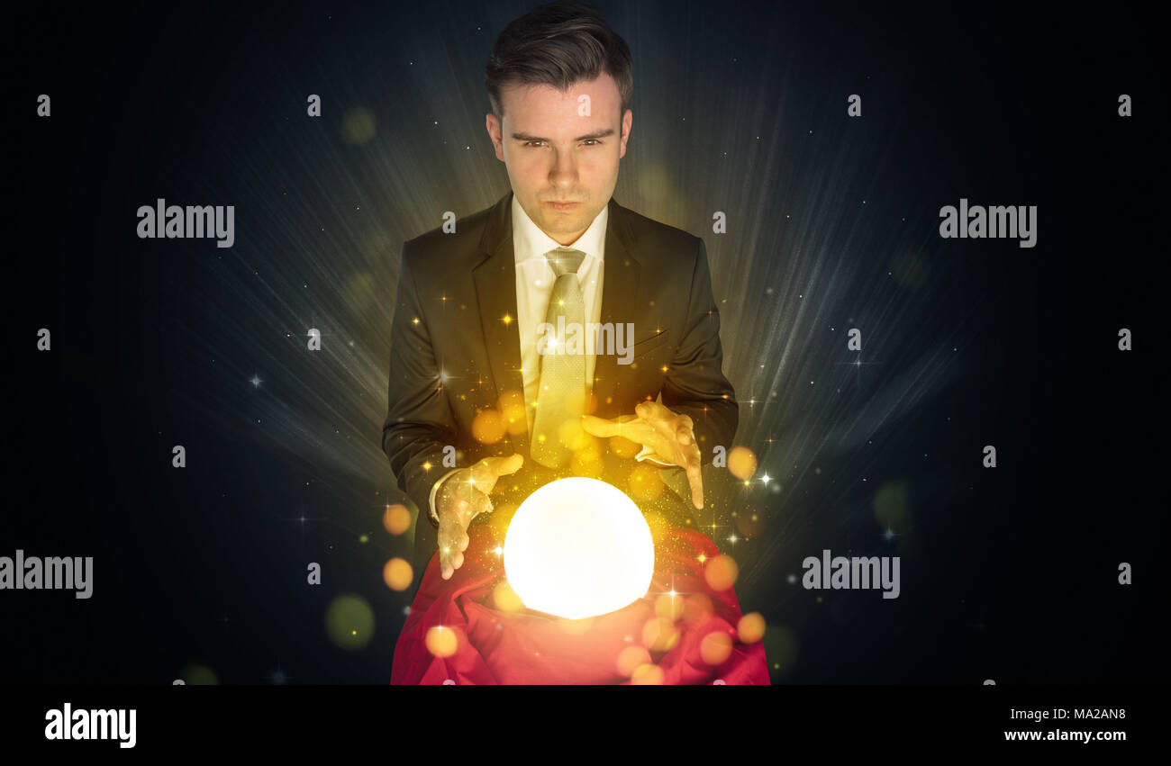 Gorgeous businessman sitting with sparkling magic ball in his lap Stock ...