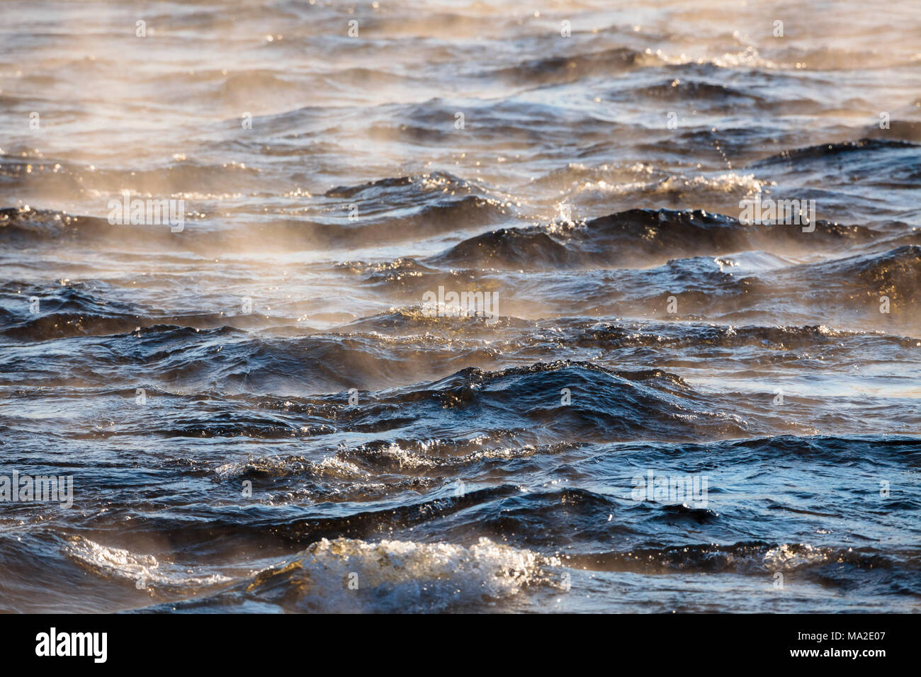 Water vapor on surface of cold icy water at sunny cold winter day Stock Photo