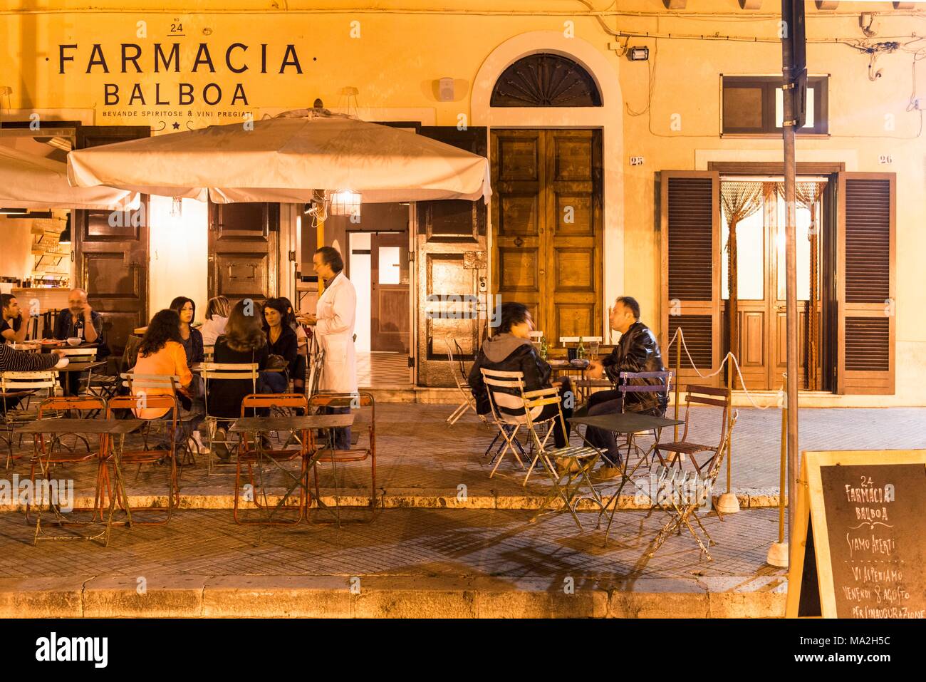People enjoying an imperative at the Farmacia Balboa wine bar in Tricase, Italy Stock Photo
