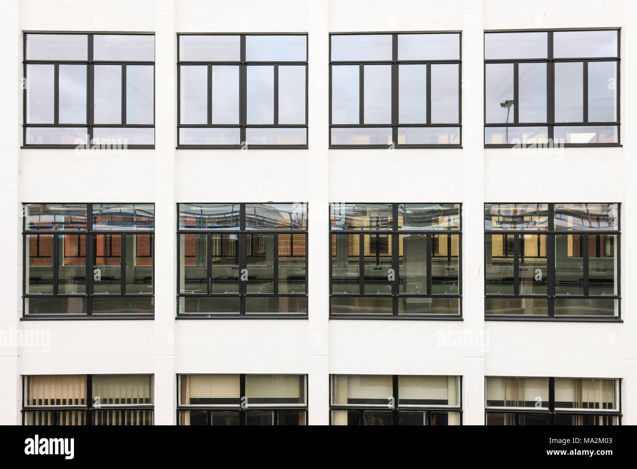 A view the windows of an empty office block. Stock Photo