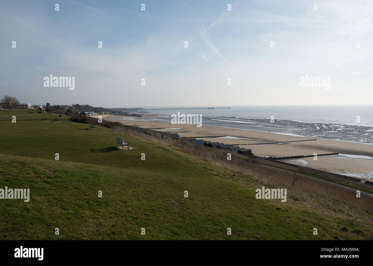 The view from the Greensward at Frinton-on-Sea looking towards Walton-on-the-Naze with a very low tide exposing all the beach below Stock Photo