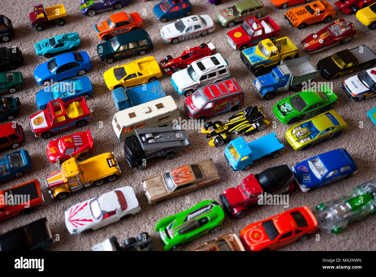 Toy cars lined up on carpet floor, England, UK. Stock Photo
