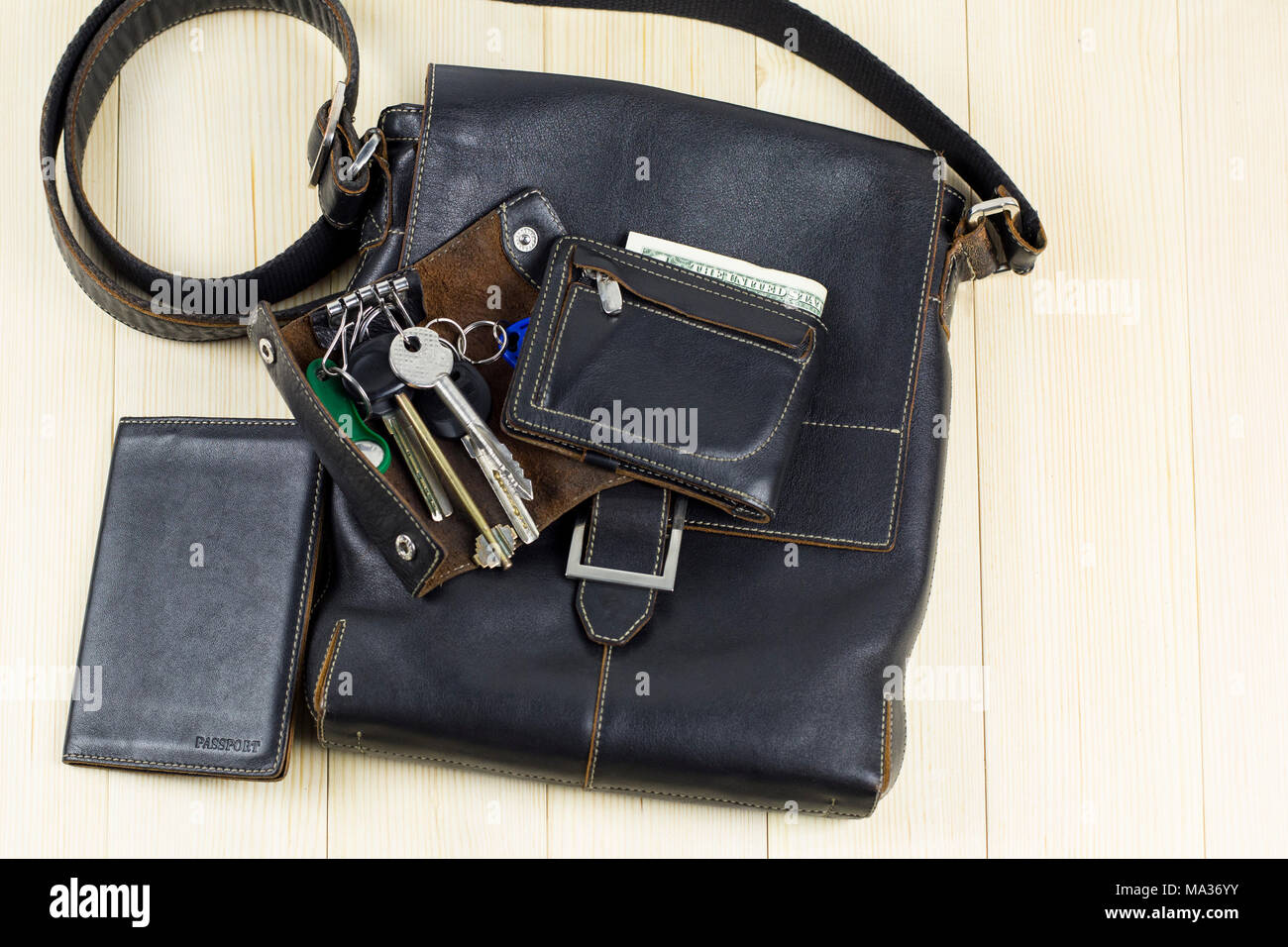 A set of men s leather accessories a bag a passport cover a wallet a handbag a keychain case on a light background Stock Photo Alamy