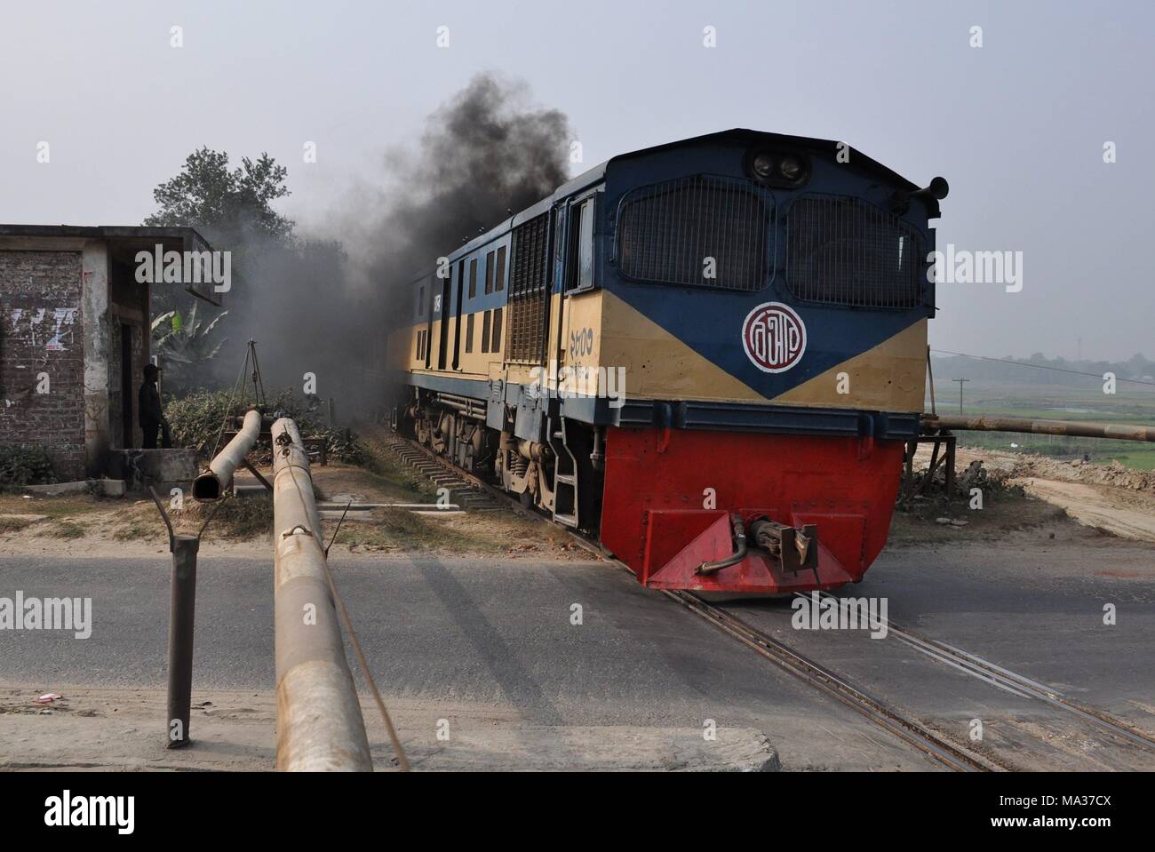 Railroad crossing and train with diesel locomotive 2803 near Narsingdi ...