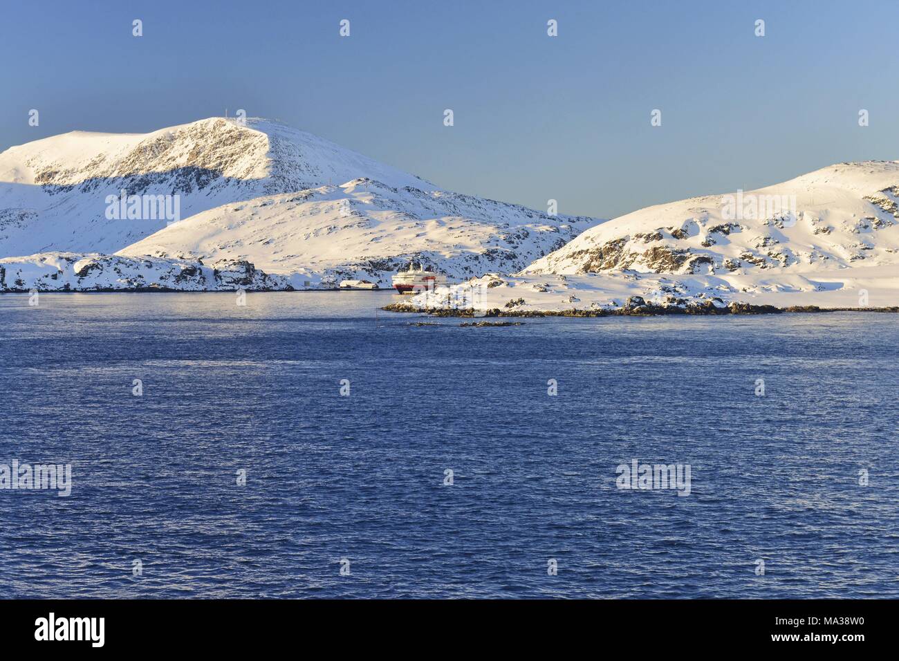 Hurtigruten Ship In The Distance Between The Mainland And The