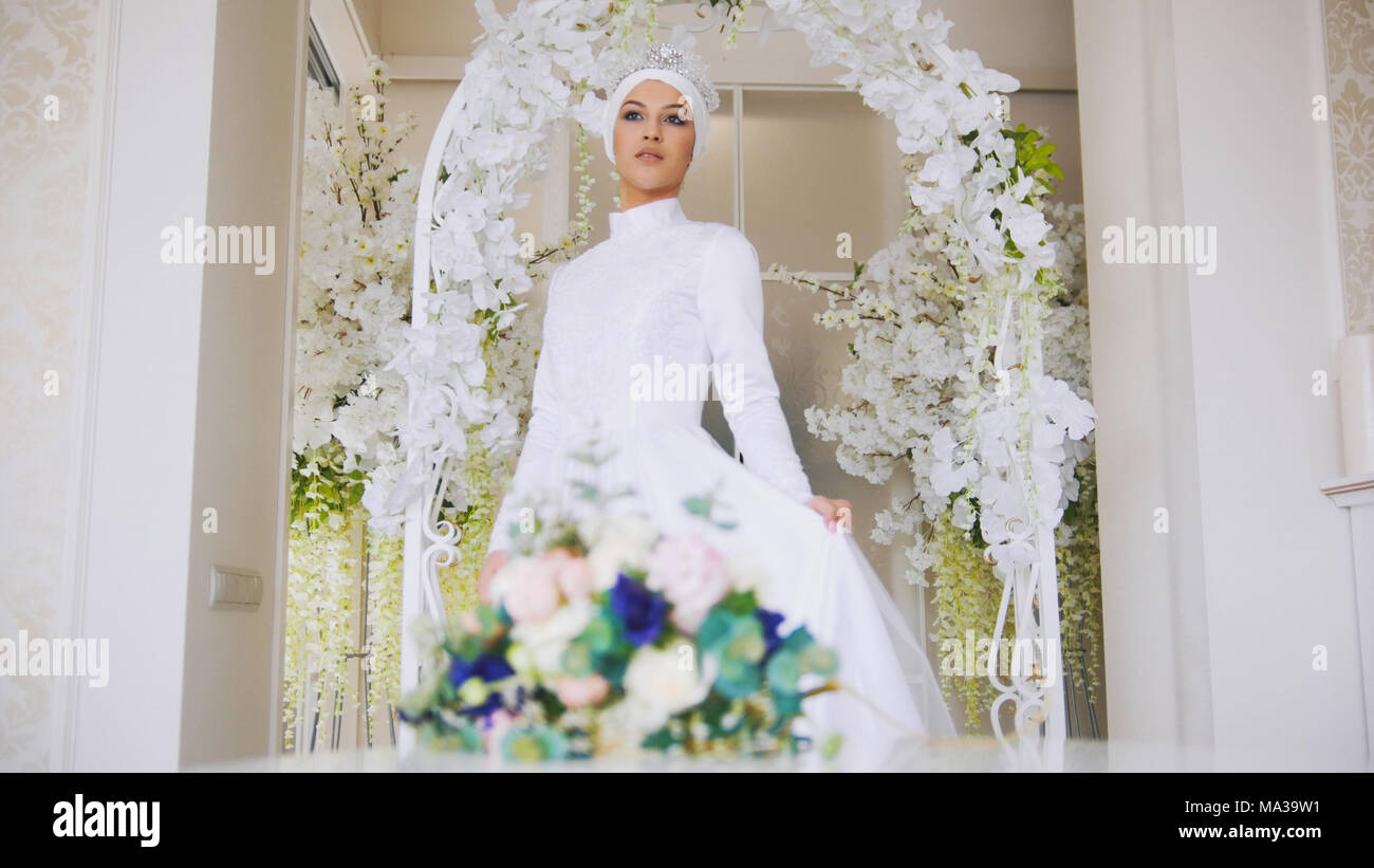 Beautiful Muslim Bride With Make Up In White Wedding Dress Comes