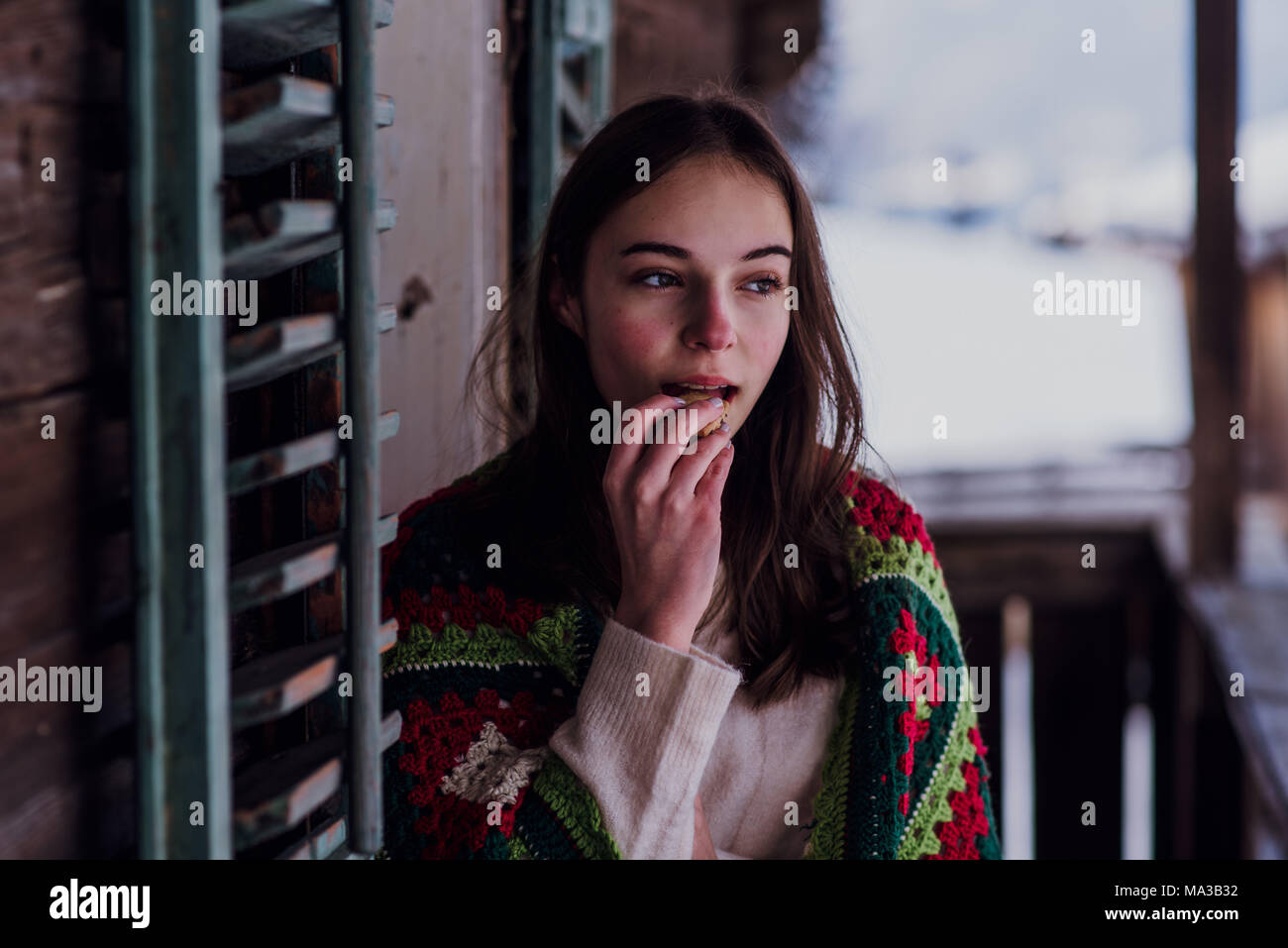 young woman,wrapped in a blanket sitting on the balcony,portrait Stock ...