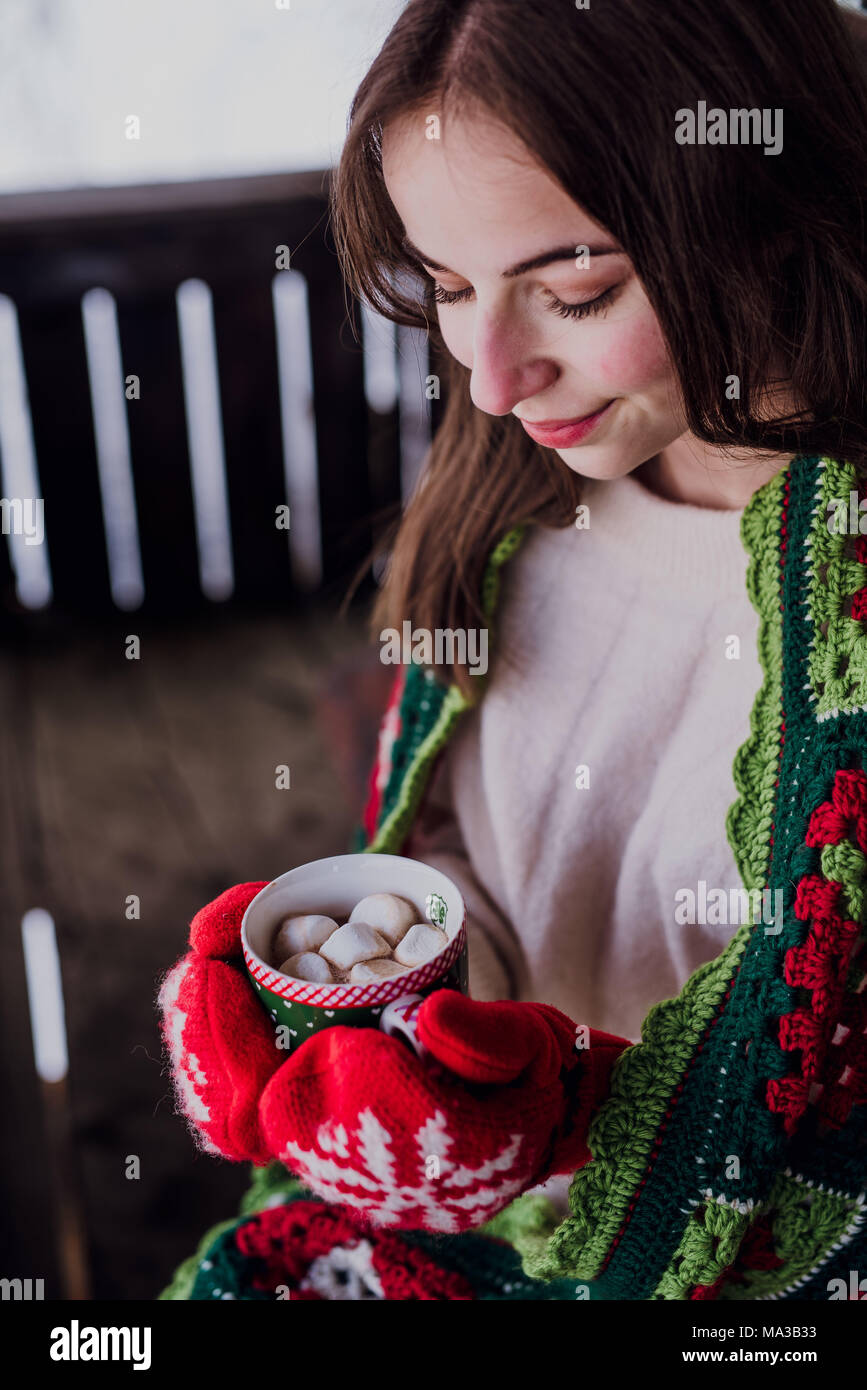 young woman wrapped in a blanket,holding a cup,detail, Stock Photo