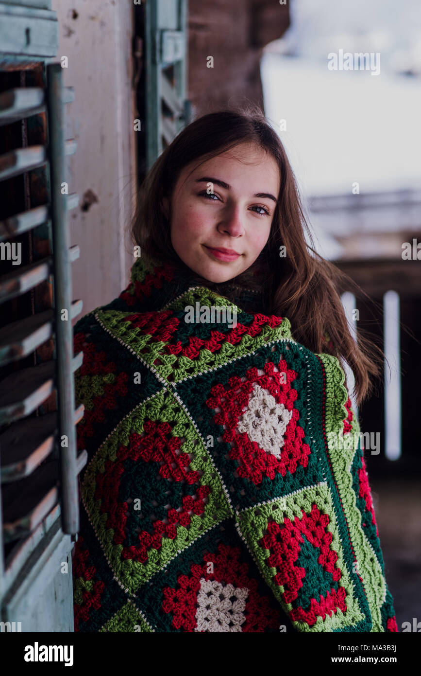 young woman,wrapped in a blanket sitting on the balcony,portrait Stock ...