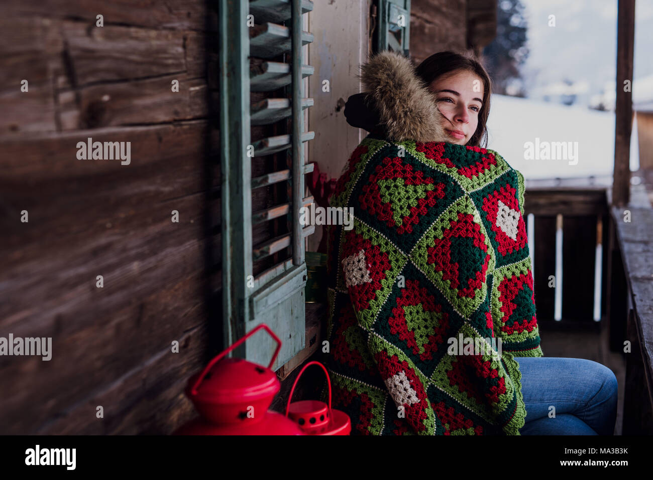 young woman,wrapped in a blanket sitting on the balcony Stock Photo - Alamy