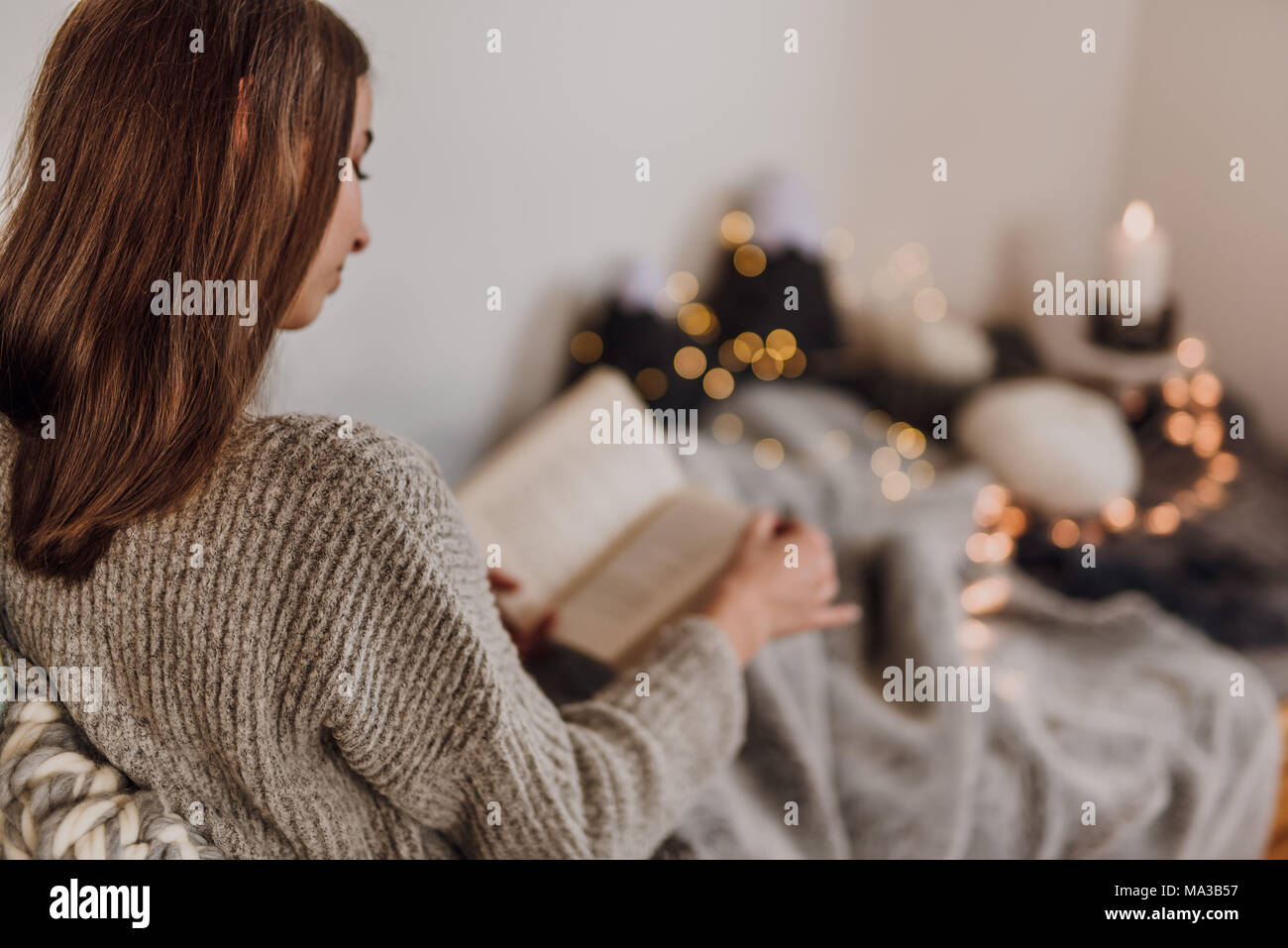 Young woman reading a book,cosy atmosphere Stock Photo