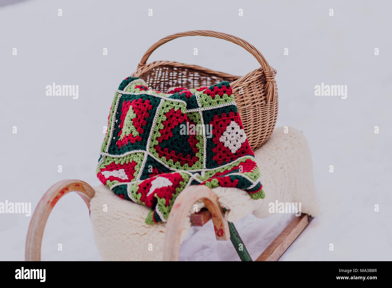 Sledge with wicker basket,blanket and fur in the snow, Stock Photo