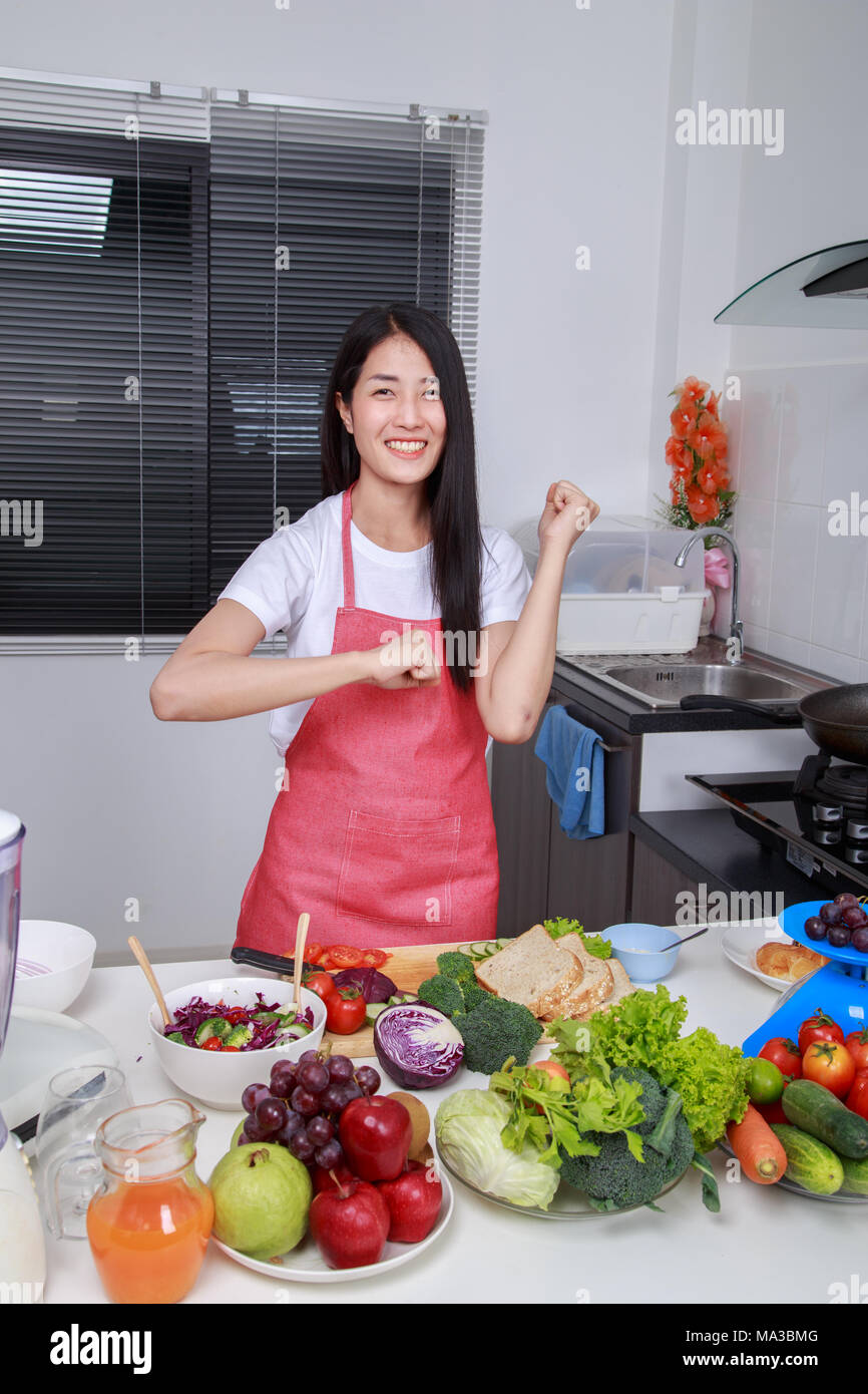 happy beautiful woman cooking in kitchen room at home Stock Photo