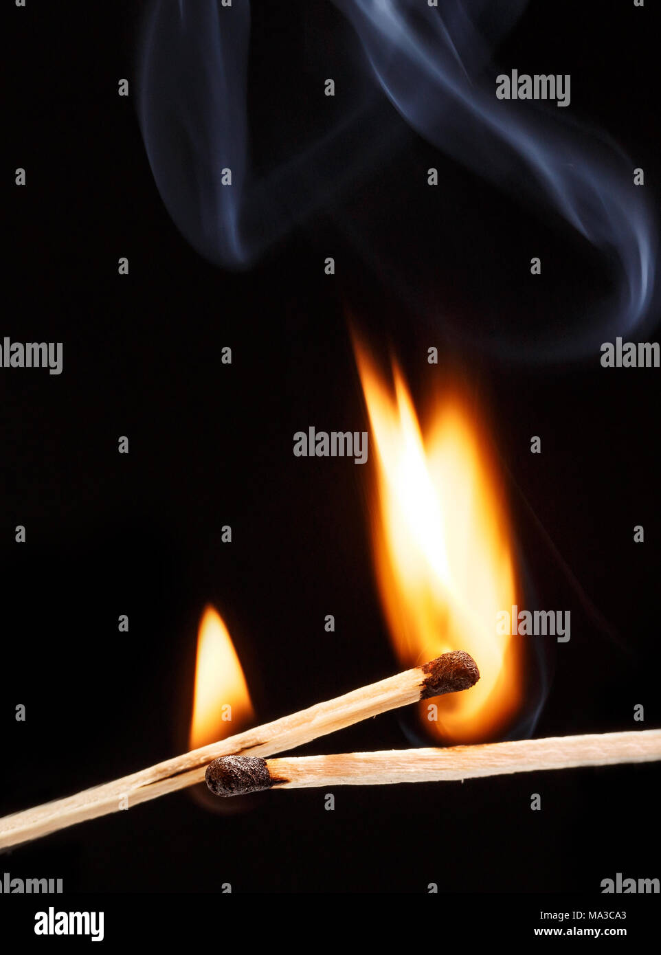 two burning match with the flame isolated on black background Stock Photo