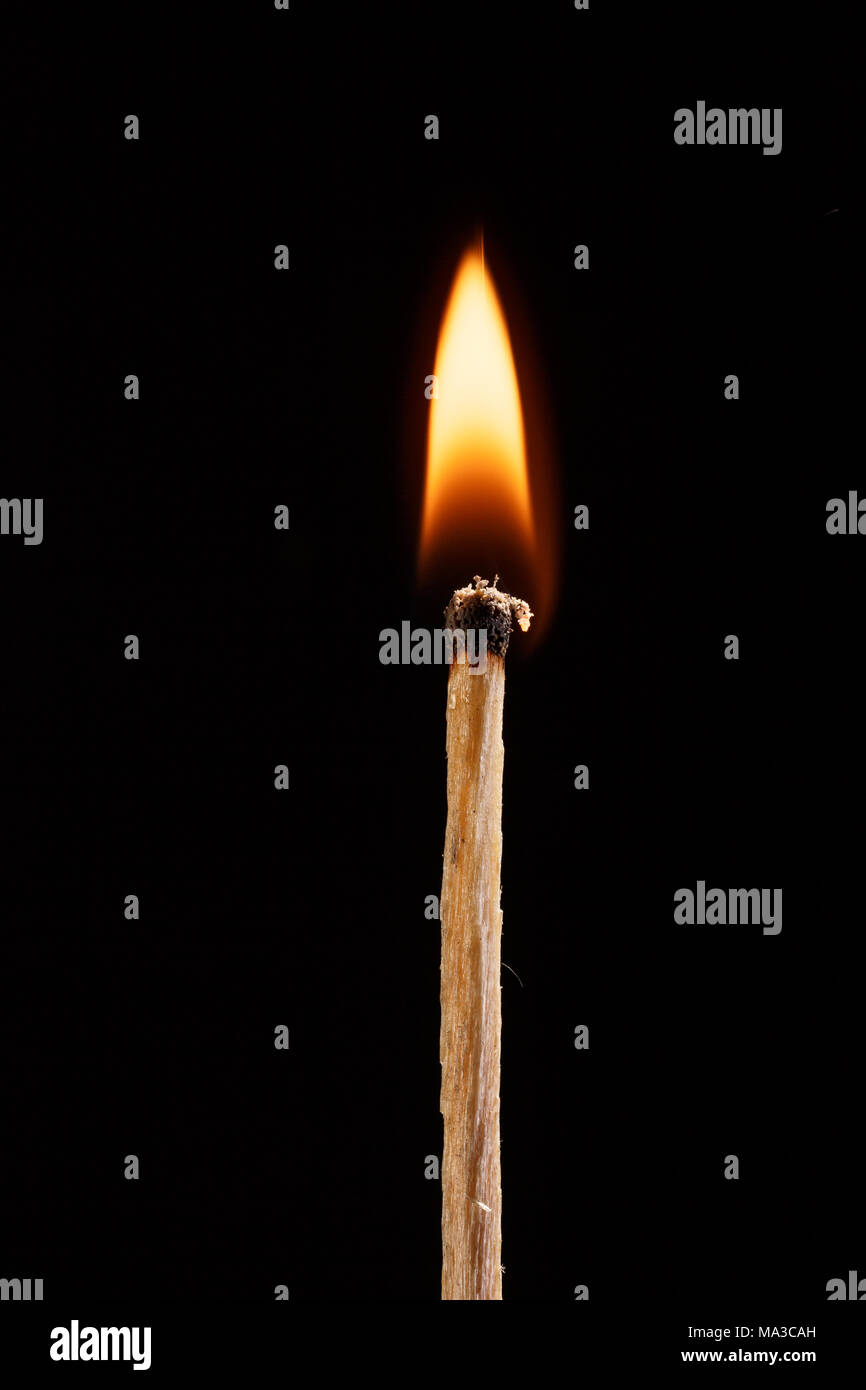 burning match with the flame isolated on black background Stock Photo