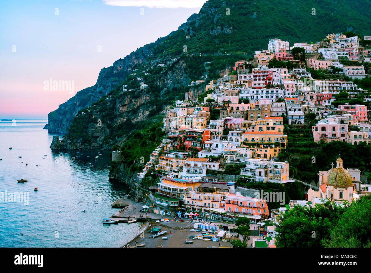 Positano, Amalfi Coast, Campania, Sorrento, Italy. View of the town and the seaside in a summer sunset Stock Photo