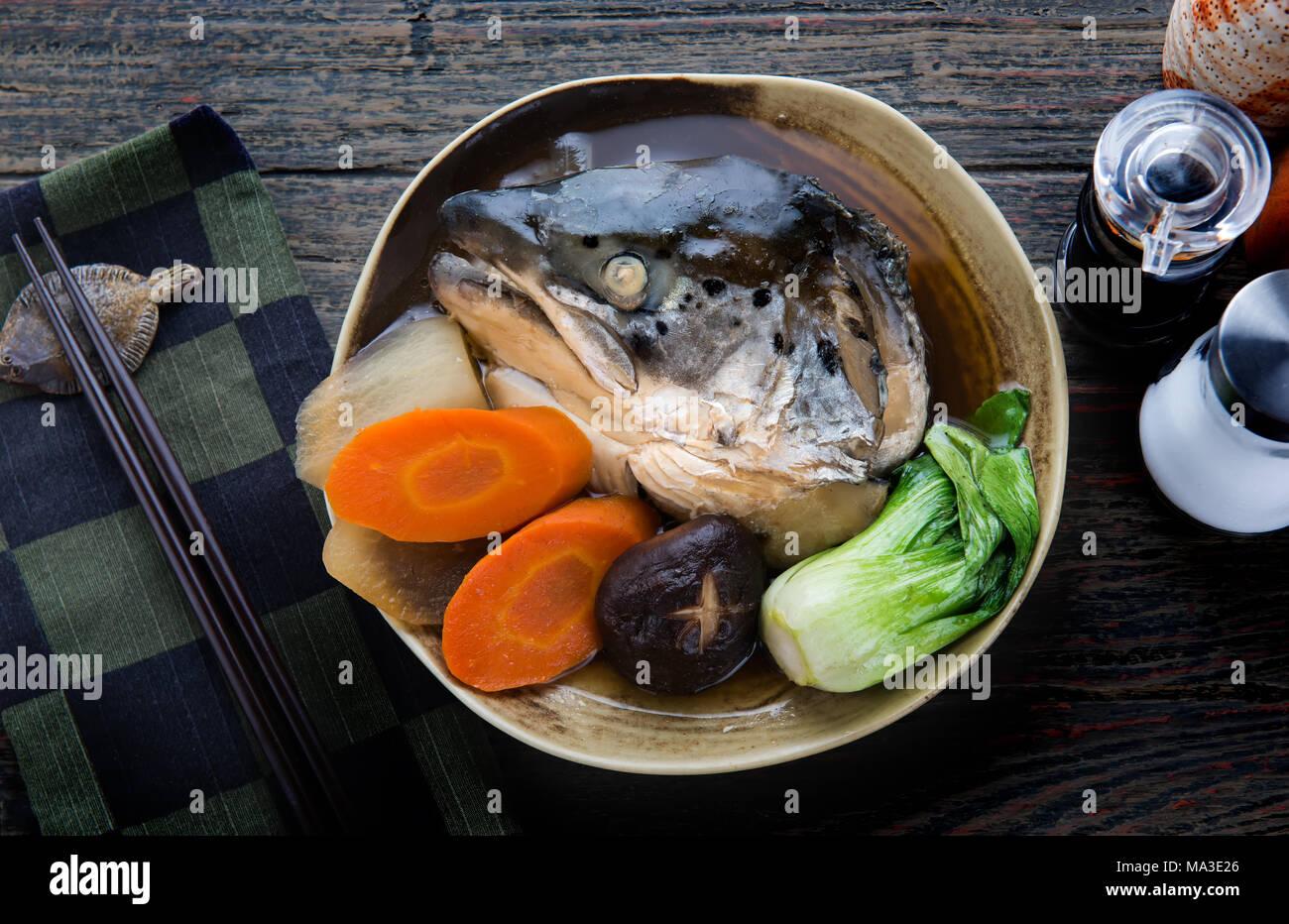 Salmon head in soya soup steamed with ingredient in Japanese style food
