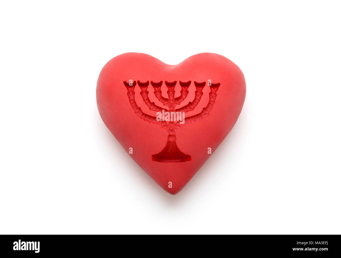 Red heart with imprinted menorah over white background with clipping path Stock Photo