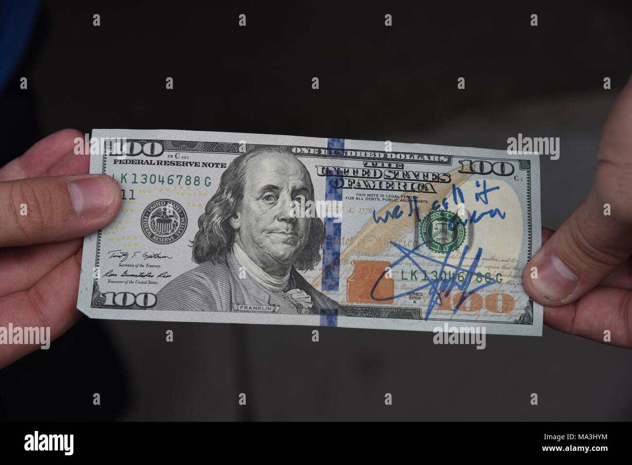 New York, NY, USA. 29th Mar, 2018. John Cena signed $100 for fan James  Gisante to make up for his bad movies at BUILD Series. Cena pulled this  $100 out of his