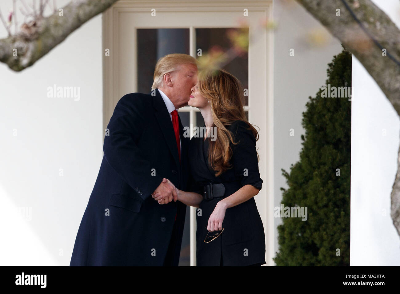Washington, USA. 29th Mar, 2018. U.S. President Donald Trump (L) kisses outgoing White House Communications Director Hope Hicks on the West Wing Colonnade before departing from the White House in Washington, DC, the United States, on March 29, 2018. Credit: Ting Shen/Xinhua/Alamy Live News Stock Photo