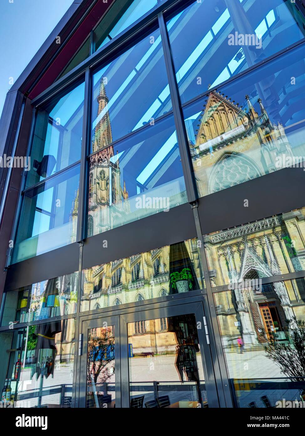 The Mariendom (New Cathedral) reflected in the glass façade of the Hotel am Domplatz in Linz, Austria Stock Photo