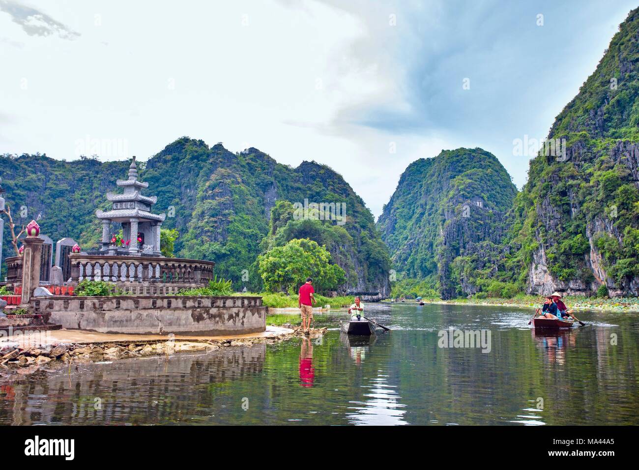 Tourist boats in the bay of Ninh Binh, also known as Dry Ha Long Bay, in Vietnam Stock Photo