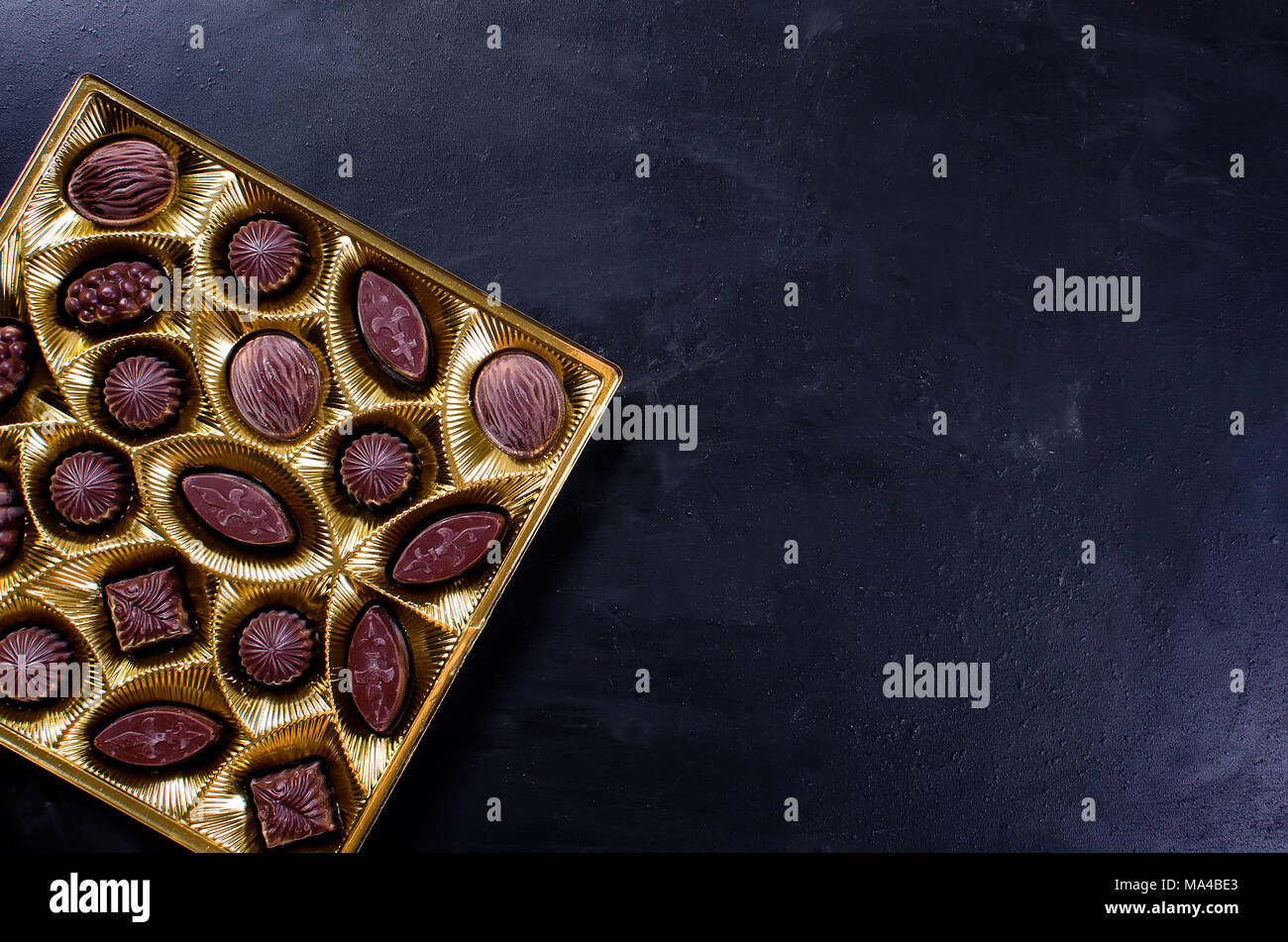 chocolate candy in a box on a black background Stock Photo Alamy