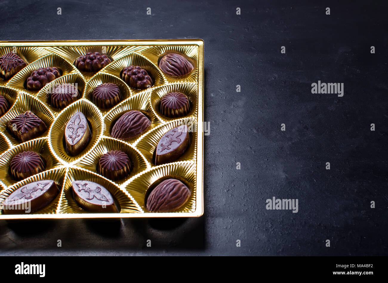 chocolate candy in a box on a black background Stock Photo Alamy