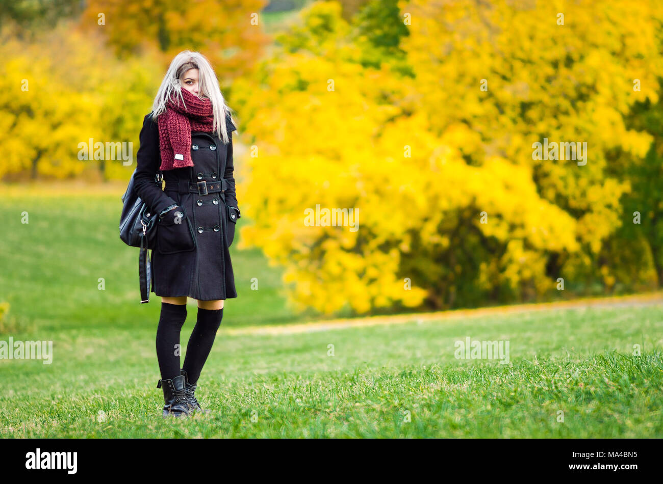 Young college woman posing in park Stock Photo