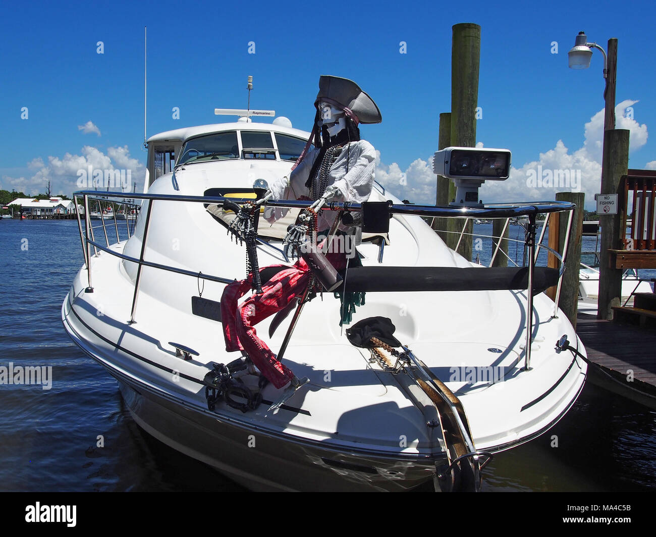 Skeleton Pirate atop a boat moored at a marina on San Carlos Island, Fort Myers, FL © Katharine Andriotis Stock Photo