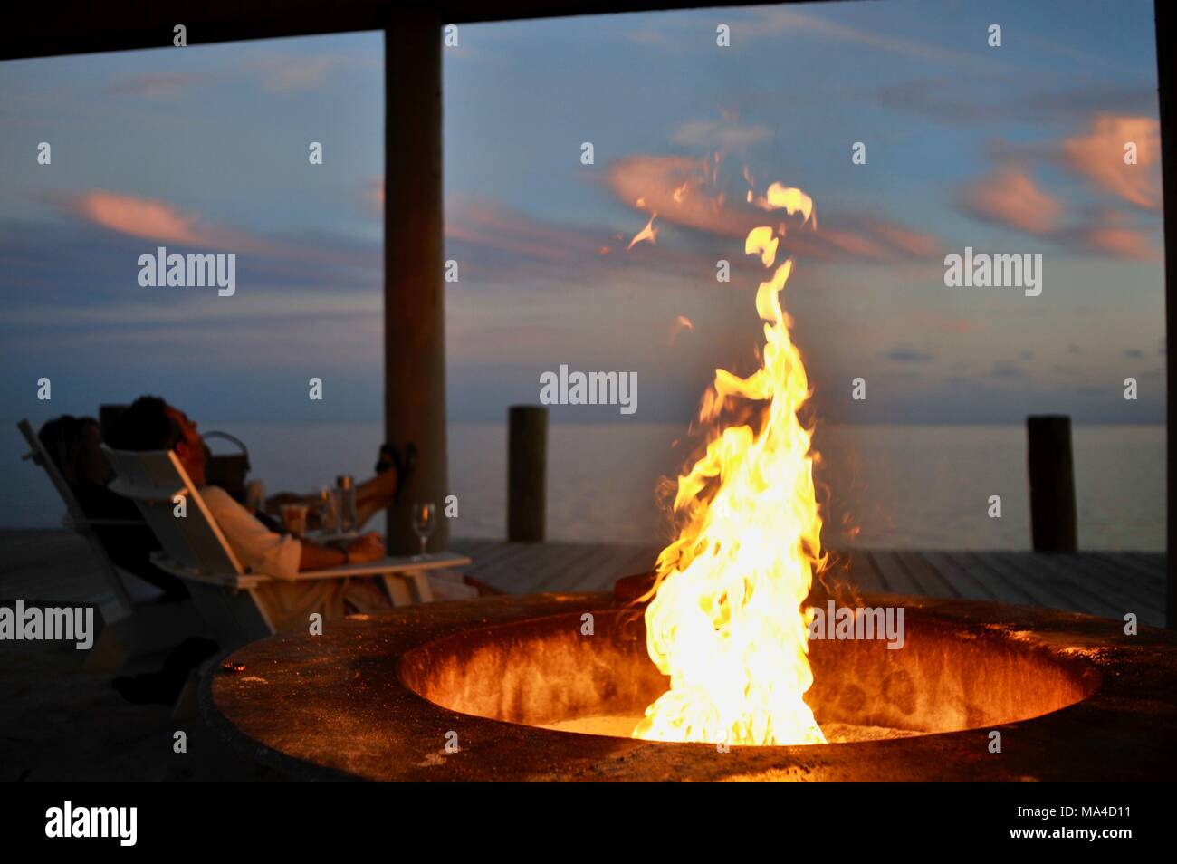 Flickering Flames In Outdoor Fire Pit Along Pier In Florida Keys