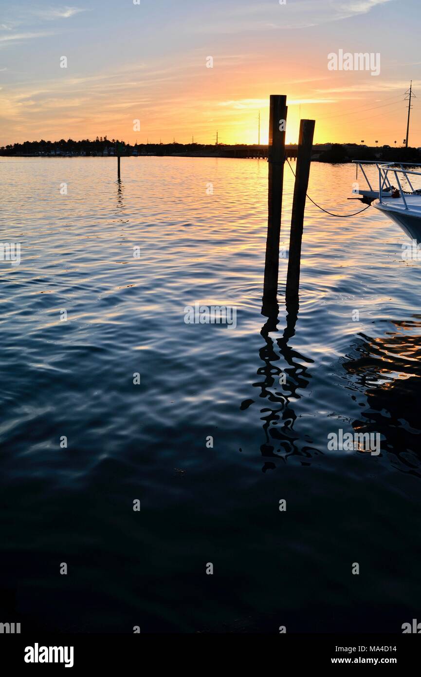 Deep sea fishing boat tied up at sunset in harbor at Islamorada