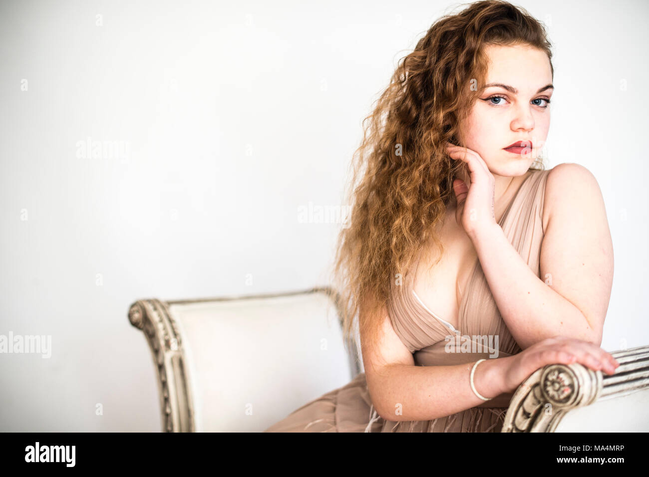 A attrractive young 13 thirteen year old teenage adolescent girl , with lomng wavy red brown hair UK Stock Photo