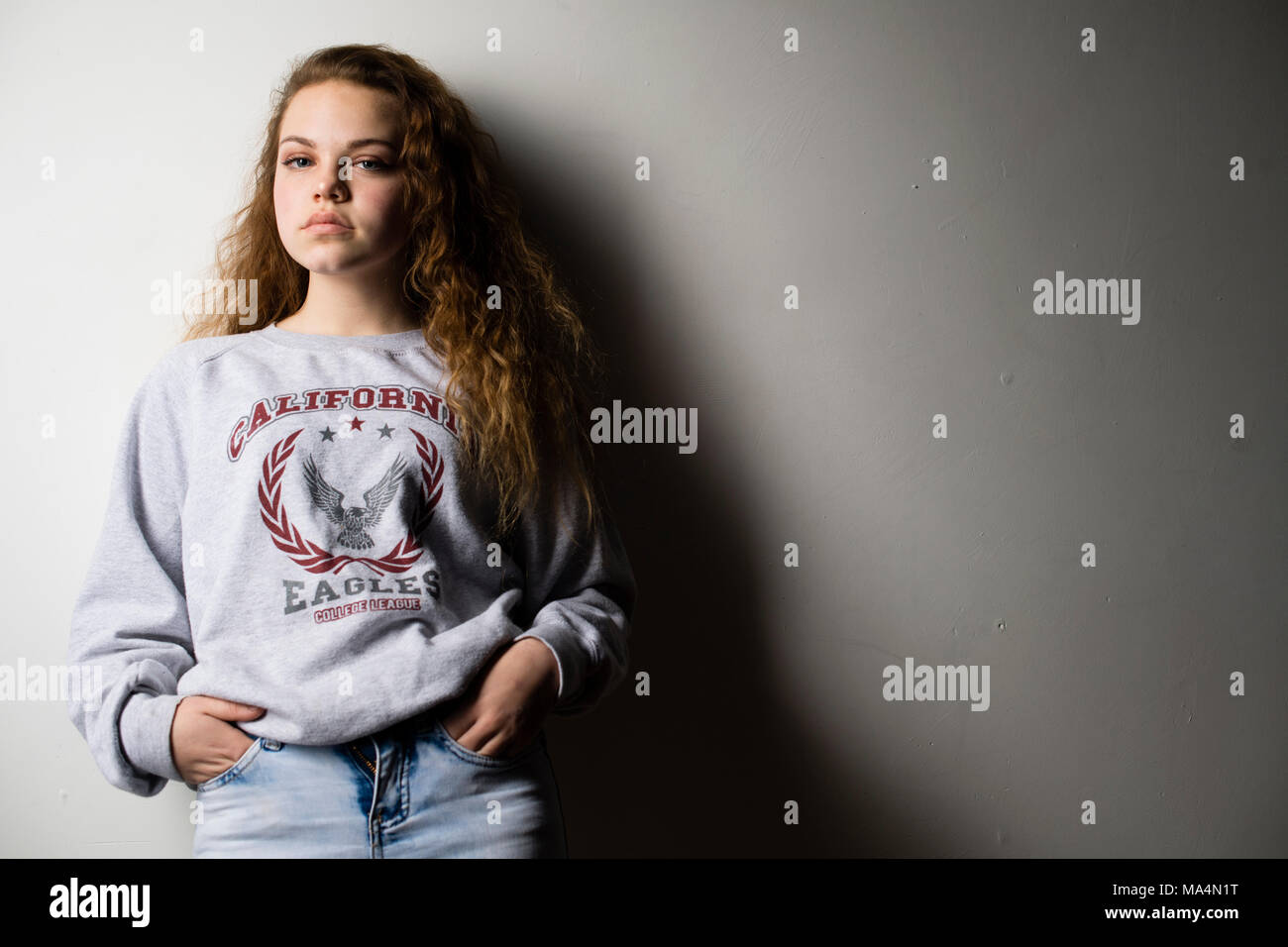 A moody attrractive young 13 thirteen year old teenage adolescent girl , UK Stock Photo