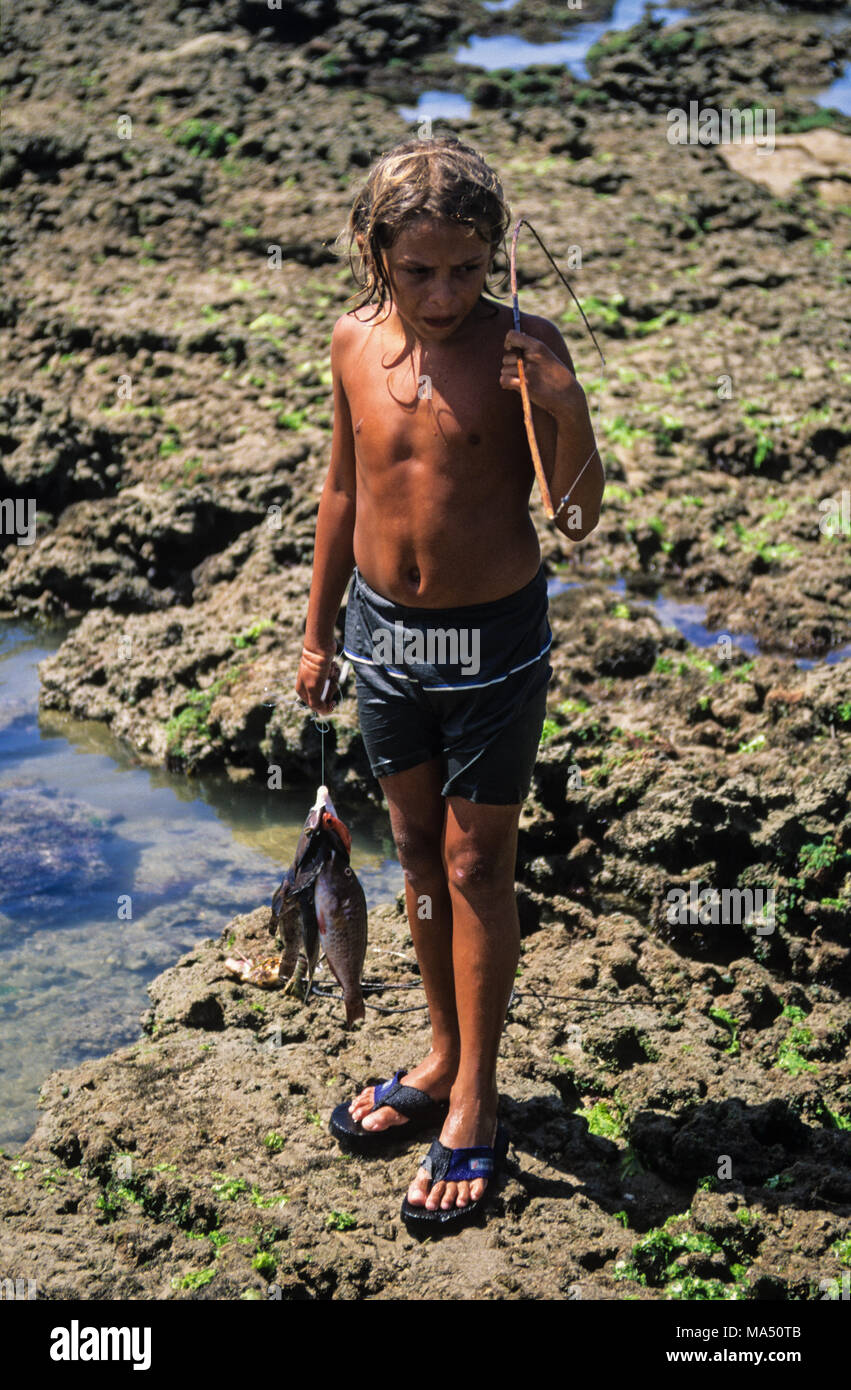 Young Boy Fishing, Pipa Beach, Natal, Rio Grand do Norte, Bazil, South America. Stock Photo