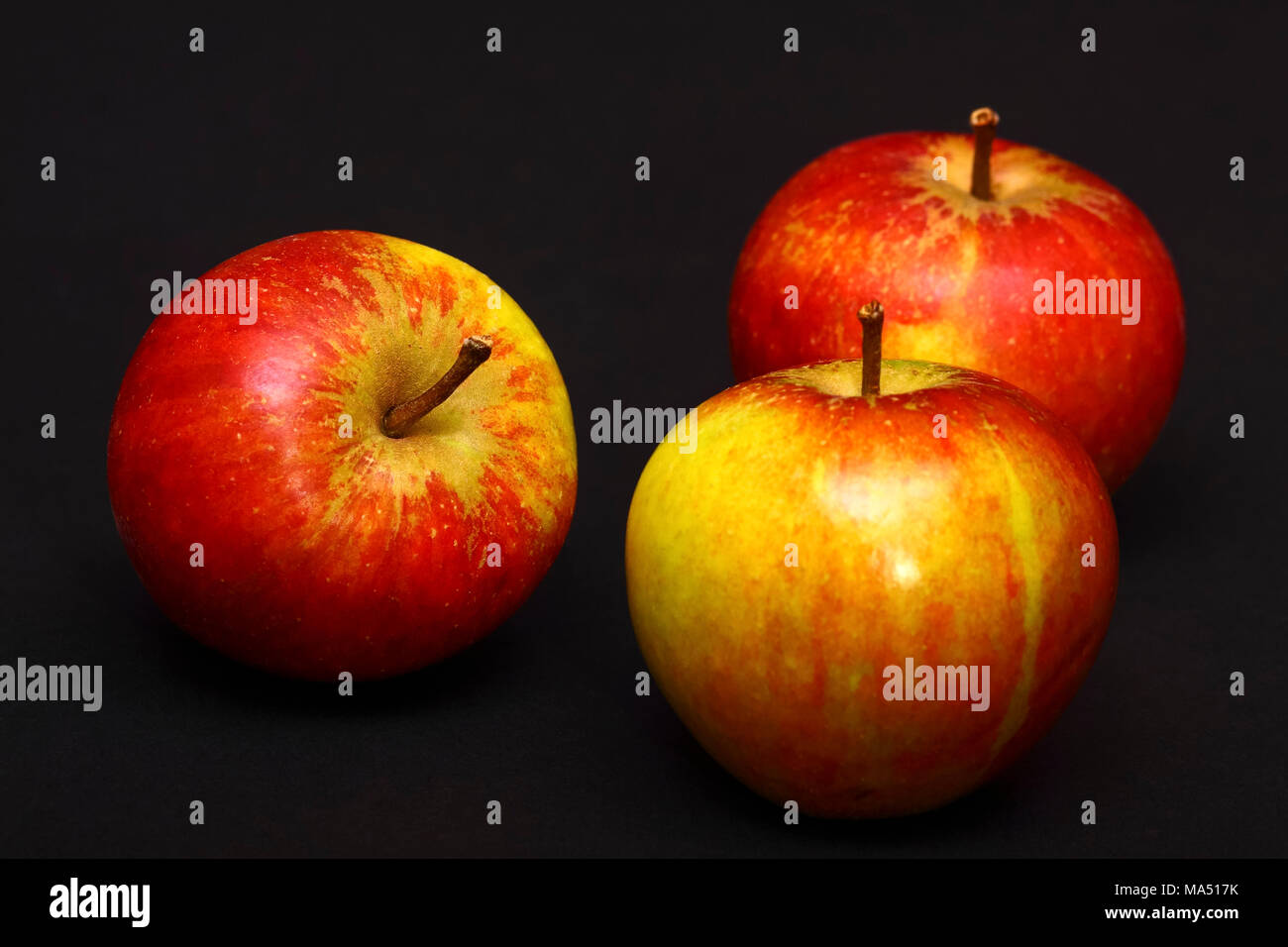 Three red ripe apples isolated on a black background Stock Photo