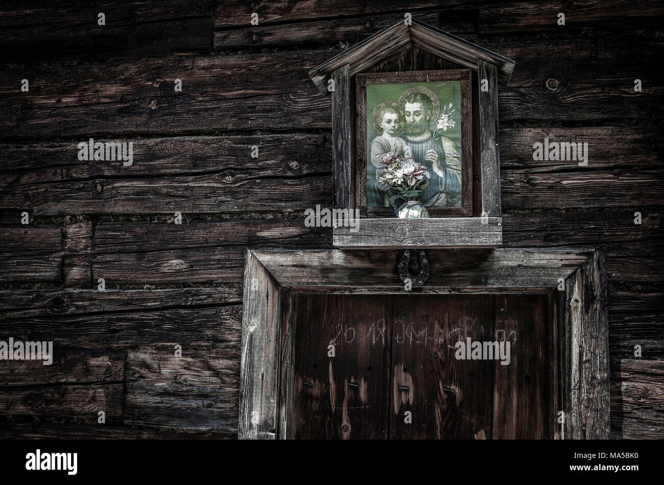 Picture of a saint above the entrance of an alpine hut in the Pinzgauer Grasbergen Stock Photo