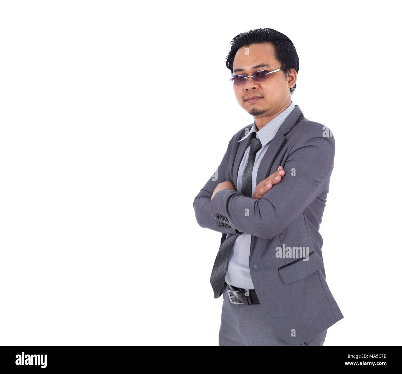 business man in suit with arms crossed isolated on a white background ...