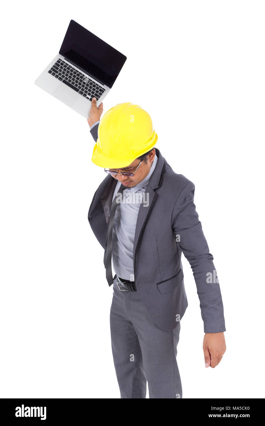 very angry engineer is throwing away his laptop isolated on a white