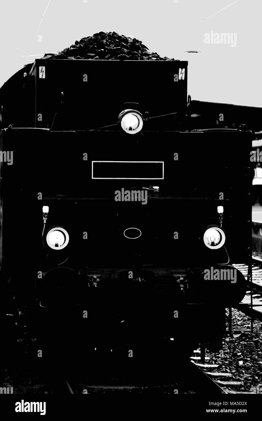 Front view of an old steam locomotive with coal for heating the boiler, Stock Photo