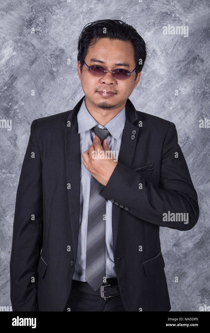 business man in a suit fixing his tie Stock Photo - Alamy